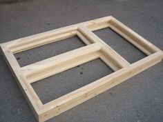 three square wooden frames sitting on the ground