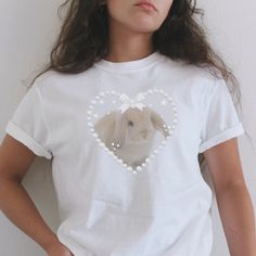 Fluffy bunny, so soft and delicate ʚɞ ♡ More of Coquette Aesthetic: https://www.etsy.com/shop/RainieshopDesign?ref=seller-platform-mcnav&section_id=1   PRODUCT DETAILS   ♡ Gildan Heavy Cotton™ Tee ♡ Made with 100% cotton ♡ Midweight fabric (5.3 oz/yd² (180 g/m ♡ Loose fit ♡ Sewn-in label ♡ Runs true to size  SIZING   ▸ Please refer to the last picture with size chart for sizes and product dimensions.  ▸ Be aware that these shirts are baby tees that can have a snug fit if you choose your normal s Fluffy Bunny, Rabbit Baby, Relaxed Style, Kids Tops, Infant Tees, Sew-in Labels, Snug Fit, Animal Lover, Loose Fitting