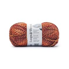 an orange and brown yarn ball on a white background