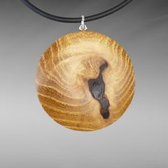 Beautiful, elegant handmade wooden pendant, round (Ø 40 mm/1.57 inch) with an oval surface on both sides, made from genuine robinia wood on a round rubber band (Ø 2 mm/0.08 inch) with a lobster clasp made from 925 silver. ⸙ The wooden pendant is oval on both sides. The surfaces are finely sanded and the outer edges are subtly rounded. The oval back/front and the warmth of the wood make the necklace very comfortable to wear on the skin of your décolleté. ⸙ MATERIALS: »» Wood type: Robinia wood (R Handmade Wooden Pendant Jewelry, Handmade Natural Wood Pendant Jewelry, Unique Natural Wood Pendant Jewelry, Nature-inspired Wooden Pendant Jewelry, Handmade Round Wooden Jewelry, Handmade Round Natural Wood Jewelry, Round Wood Jewelry As A Gift, Round Wooden Jewelry For Gifts, Round Wooden Jewelry Gift