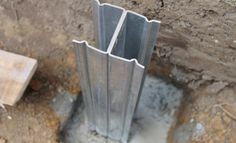 an image of some metal pipes in the ground