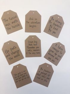 six brown tags with handwritten words on them