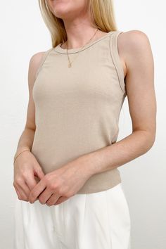 The Everly Ribbed Knit Tank Top is lightweight basic that pairs seamlessly with any pair of pants or shorts. This casual tank can be warn as a layering piece or on it's own. Featuring a ribbed knit fabric, high neckline, tan color and a racerback. Style this basic tank with high waited pants for a casual look! Details & Sizing Ribbed knit fabric High neckline Tan color Racerback Gabriella is wearing a size S Fabric 95% Rayon 5% Spandex Shipping & Returns This item is Final Sale Beige Ribbed Cotton Tank Top, Spring Ribbed High Stretch Tank Top, Stretch Ribbed Crew Neck Tank Top, High Stretch Ribbed Tank Top For Spring, Basic Stretch Knit Top, Basic Solid Color Stretch Knit Top, Stretch Ribbed Tops For Summer, Summer High Stretch Ribbed Tank Top, High Stretch Ribbed Tank Top