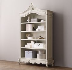 a white bookcase sitting on top of a wooden floor