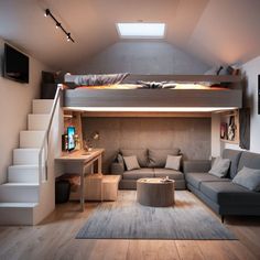 a loft bed is built into the side of a living room with stairs leading up to it