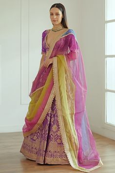 Features a purple banarasi silk lehenga teamed with a plunging V-neck banarasi blouse with sequinned booties on the sleeves. Completed with a multicoloured Ombre net dupatta. Composition : Banarasi Silk, Net Care: Dry Clean Only and Vacuum Storage This product can be customised for sleeves, length of blouse and neckline Delivery : 4-6 weeks as the product is hand crafted. For more information and sizes please contact fabiliciousfashion@gmail.com or visit our Copenhagen studio. Studio Iris, Indian Outfits Lehenga, Lehenga Designs Simple, Gaun Fashion, Vacuum Storage, Couture Wedding Gowns, Indian Dresses Traditional, Indian Bridal Dress, Indian Wedding Wear