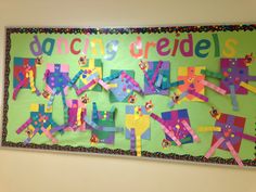 a bulletin board with colorful paper cutouts on it