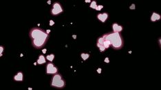 many pink hearts floating in the air on a black background with white and red lights