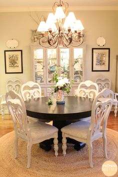 a dinning room table with chairs around it