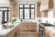 a kitchen filled with lots of wooden cabinets and white counter tops next to an oven