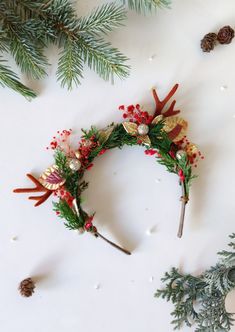 a christmas wreath with pine cones and berries