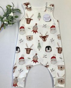 "Santa's friends print organic romper, fun baby and toddler wear, baby gift, baby clothes, stretchy dungarees, handmade to order. This beautiful organic romper is the ideal baby outfit, bringing festive joy and fun to baby wear.  Rompers are made using a harem style pattern  to provide extra room for your little one to grow and move freely. I use high quality GOTS certified, organic jersey which is perfect for delicate skin.  Each romper has two KAM shoulder poppers to provide quick and easy nap Baby Dungarees, Baby Coming Home Outfit, Toddler Wearing, Fun Baby, Toddler Romper, Festive Wear, Coming Home Outfit, Baby Outfit, Perfect Baby Shower Gift