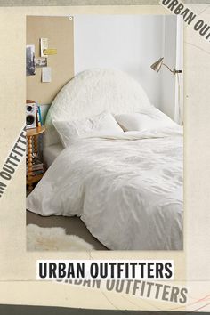 an advertisement for urban outfitters featuring a bed with white comforter and pillows on it