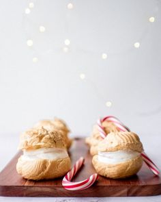 two pastries on a wooden board with candy canes