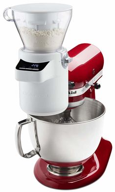 a red and white mixer sitting on top of a bowl