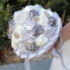 a bridal bouquet with white roses and pearls