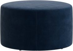 a large blue ottoman sitting on top of a white floor