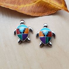 Visit our on-line shop at: Etsy.com/shop/AlbuquerqueDesigns *sterling silver earrings / dainty sea turtle *studs / posts *southwestern jewelry *bright inlay multicolor *calibrated pre-cut stone: 9x7mm teardrop shape *all jewelry items are made to ship, slight variations in stones will occur comparing to pictures *size of a penny is 19mm or a dime is 18mm dime for comparing size with jewelry item *handcrafted in Albuquerque, New Mexico, USA *free convenient gift box *free shipping in USA *seller Hypoallergenic Multicolor Sterling Silver Earrings, Multicolor Hypoallergenic Sterling Silver Jewelry, Hypoallergenic Multicolor Sterling Silver Jewelry, Multicolor Sterling Silver Earrings For Gift, Rainbow Sterling Silver Earrings, Sea Life Jewelry, New Mexico Usa, Albuquerque New Mexico, Southwestern Design