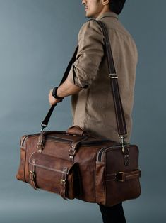 Trustpilot This is one perfect solution for all your needs. This leather duffle bag has four big pockets in the exterior with two buckles. This leather duffle bag is made of genuine goat leather which gives it a rustic look which is for everyone who is looking for something heavy-duty but with good looks. This leather bag has three compartments, one big compartment for all your clothes and shoes, two small compartments with a zipper for all of your accessories. A perfect one for every situation Leather Duffle Bag Men, Stylish Leather Bags, Leather Briefcase Bag, Leather Weekender Bag, Leather Weekender, Leather Craftsmen, Leather Duffle Bag, Clothes And Shoes, Big Pockets