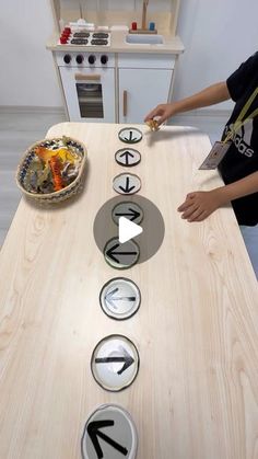 a person standing in front of a wooden table with plates and bowls on top of it