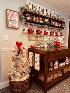 a small christmas tree sitting in front of a shelf filled with gifts and other items