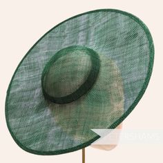 *This is not a fitted hat! You will need to attach a headband, comb or elastic to secure it to your head* This bottle green cartwheel hat base is a classic shape that has sprung into popularity in the past year. Made from 2 layers of stiffened sinamay, these cartwheels are ready to trim and are fitted with a petersham ribbon on the inside crown edge. Simply add a comb or headband to secure to the head. Hat base measures: Width: 35.5cm (14 inches) Crown Width: 13.5cm (5.3 inches) Crown Height: Approximately 3.5cm (1.7 inches) In this listing we give you the option of attaching an elastic, this is to help secure the fascinator base to your head as it is not a fitted/finished headpiece. If you would prefer to use a headband or a comb, these can be purchased separately in our shop for you to s Green Boater Hat With Flat Brim For Summer, Adjustable Green Hat Band For Summer, Green Summer Boater Hat With Flat Brim, Green Flat Brim Boater Hat For Summer, Green Boater Hat With Curved Brim For Summer, Green Brimmed Boater Hat For Summer, Green Straw Hat With Short Brim, Adjustable Green Brimmed Boater Hat, Green Brimmed Straw Hat For Garden Party