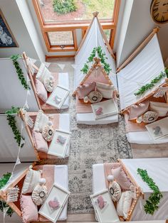 an overhead view of a room with several beds and pillows