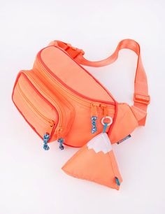 an orange fanny bag sitting on top of a white table