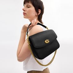 A more compact Cassie our 19 is smaller than the original and made for days or nights on the go. The polished pebble leather design is finished with a Signature turnlock closure and three interchangeable straps for versatile styling. Detach the crossbody strap and carry by hand with the leather and chain top handles together or separately. | Coach Cassie Crossbody Bag 19 - Women's Designer Crossbody - Brass/black Versatile Coach Bags With Detachable Handle, Versatile Coach Bag With Adjustable Strap, Versatile Coach Bag With Detachable Strap, Coach Pebbled Leather Shoulder Bag With Detachable Strap, Versatile Coach Satchel With Detachable Strap, Coach Pebbled Leather Satchel With Detachable Strap, Timeless Travel Bag With Fold Over Clasp, Timeless Flap Bag With Fold-over Clasp For Everyday Use, Workwear Bags With Fold Over Clasp