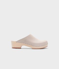 low heeled minimalistic clog mules in sand white nubuck leather stapled on a light wooden base Cork Sandals, Wooden Clogs, Timeless Aesthetic, Clog Sandals, Leather Clogs, Day To Night, To Night, Nubuck Leather, Boot Shop