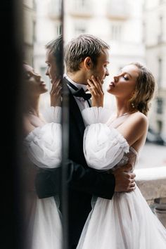 a man in a tuxedo and woman in a wedding dress kissing each other