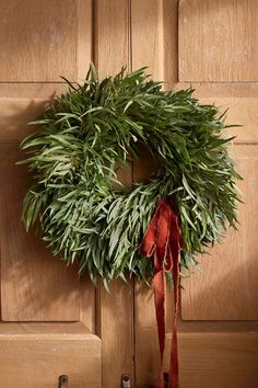 a wreath hanging on the side of a wooden door