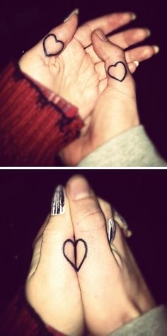 two hands with heart tattoos on their fingers