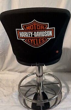 harley davidson bar stool with chrome base and foot rest on white sheeted backdrop background