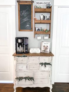 a coffee bar with chalkboard on the wall next to it and an old dresser