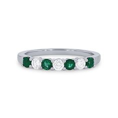 an emerald and diamond five stone ring in 18k white gold, with four diamonds on each side