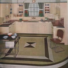 an old fashioned kitchen with white cabinets and black and white floor tiles on the walls