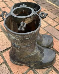 a close up of a metal boot on a brick ground with bricks in the background