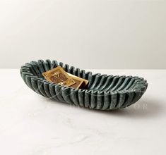 a green bowl with a gold plate in it