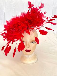 Delightful red feather Ascot hat. Mixed range of red feathers, including ostrich feathers. worn either on the top of head or on the side. Stunning piece of art on your head. Attached to the hair with a hair clip. Very light and stable on the head. Available in other colours. Dare to be Different.... Shipped in 2 days Delivery to Europe within 5-8 working days Delivery to USA within 8-18 working days. Delivery to UK within 5-10 WORKING DAYS. Delivery to Rest of the World 10-20 working days Red Fascinator, Kentucky Derby Fascinator, Derby Fascinator, Ascot Hats, Round Hat, Hat Base, Head Dress, Feather Headdress, Turkey Feathers