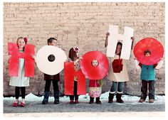 children holding up letters that spell out the word hope in front of a brick wall