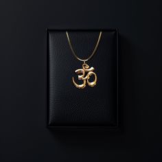 Connect with the sacred sound of the universe with our gold Om pendant, finely crafted in the USA. Representing the essence of ultimate reality, consciousness, and inner peace, each piece is a harmonious blend of spirituality and artistry. PENDANT INFORMATIONThis pendant is made of real, solid gold.• Made in USA• Size: Mini• Material: 14k or 18k solid gold• Finish: polished• Height: 0.9" (22,5 mm) | *includes the small circle, bail dimensions not included• Width: 0.85" (22 mm)• Pendant weight (a April Crafts, Om Pendant, Small Circle, Solid Gold Chains, Yellow Gold Pendants, Elegant Jewelry, Inner Peace, Consciousness, Chain Lengths