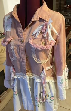 a pink jacket with white ruffles and flowers on it