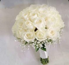 a bouquet of white roses and baby's breath