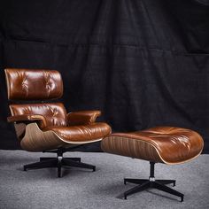 an eames lounge chair and ottoman in brown leather