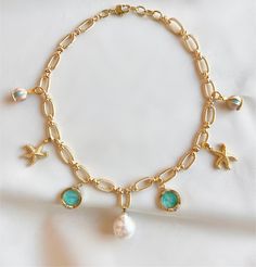 Capture the carefree and relaxed feeling of a day at the beach with our freshwater pearl charm necklace. Gold-filled charms of starfish, baby blue sea glass and merry-go-round pendants on a golden rope style chain add a laid-back luxury of coastal living. The large freshwater pearl adds a hint of sophistication making this necklace a perfect companion for breezy days and beachy nights. Size: 16 inches with a 1 inch extender Ocean-inspired Starfish Charm Necklace For Vacation, Vacation Ocean-inspired Starfish Charm Necklace, Blue Charm Necklaces For The Beach, Beach Star Charm Necklace Ocean-inspired, Beach-style Ocean-inspired Charm Necklace With Star, Beach Ocean-inspired Star Charm Necklace, Pearl Charm Necklace, Beachy Vibes, Stacked Necklaces