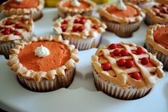 several cupcakes with red and white frosting on a plate in the shape of pies