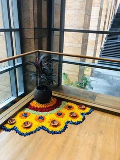 a flower rug on the ground in front of a window with stairs leading up to it