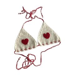 two pieces of crochet with red hearts on them are hanging from a string