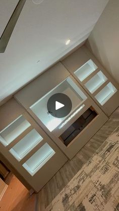 an overhead view of a living room with a ceiling fan and glass shelves on the wall